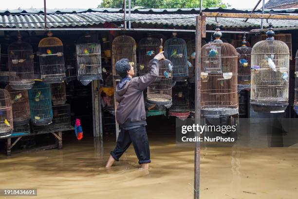 People are passing through floods in Dayeuhkolot, Bandung Regency, Indonesia, on January 12, 2024. The Citarum River is overflowing due to the high...