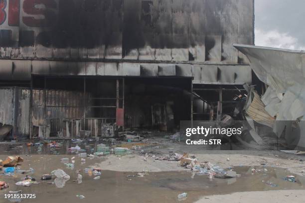 This picture shows a damaged building in Port Moresby on January 12, 2024. Troops patrolled the streets of Papua New Guinea's capital on January 12,...