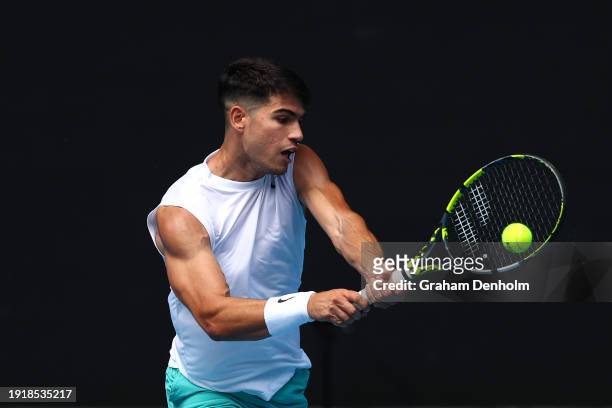 Carlos Alcaraz of Spain plays a backhand during a training session ahead of the 2024 Australian Open at Melbourne Park on January 09, 2024 in...