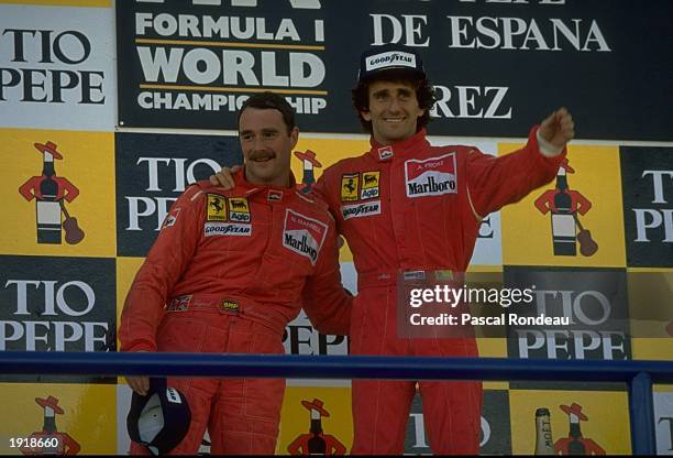 Scuderia Ferrari drivers Nigel Mansell of Great Britain and Alain Prost of France stand on the winners'' podium after the Spanish Grand Prix at the...