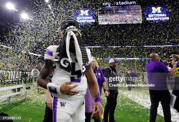 Michael Penix Jr. #9 of the Washington Huskies walks off the field after being defeated by the Michigan Wolverines during the 2024 CFP National...