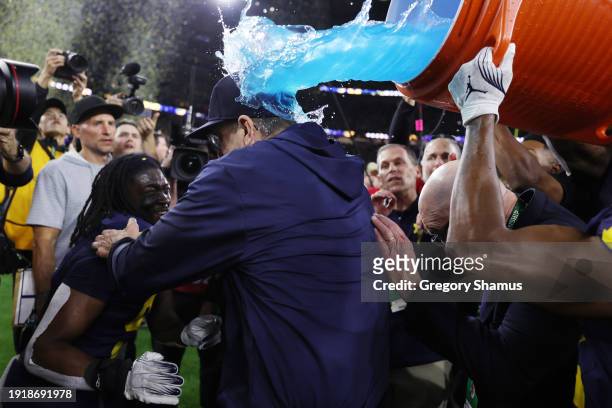 Head coach Jim Harbaugh of the Michigan Wolverines receives a Gatorade shower after defeating the Washington Huskies during the 2024 CFP National...