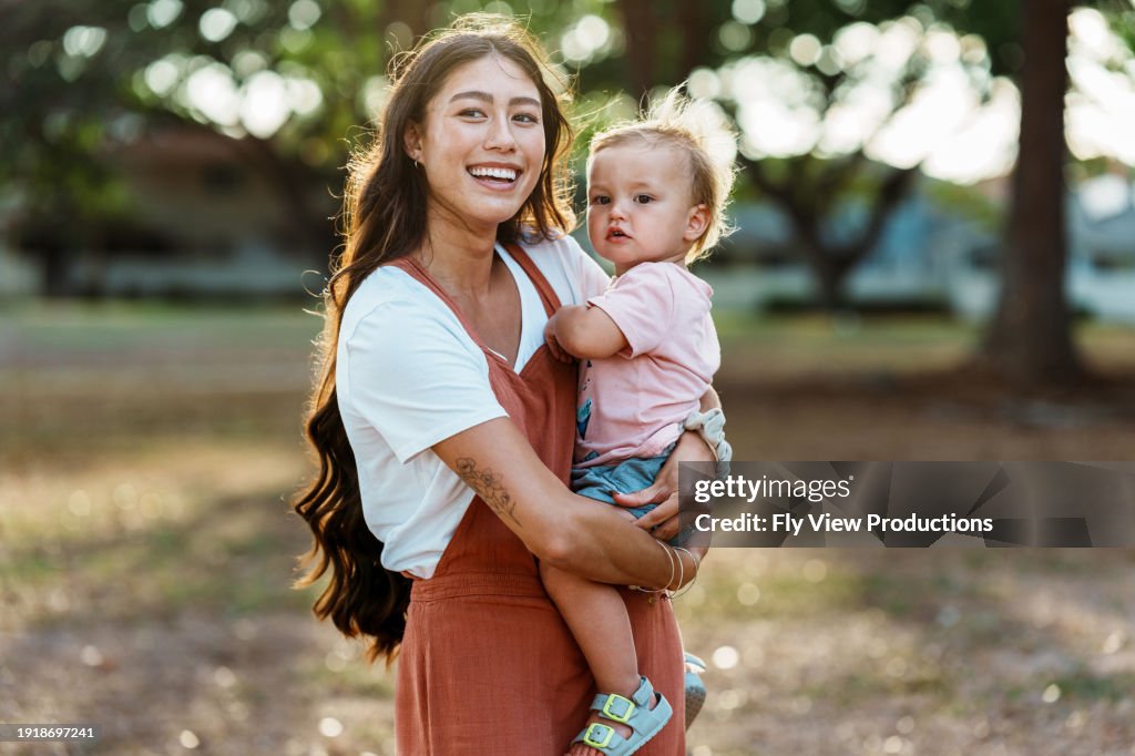 Loving mom and one year old baby enjoying time outside