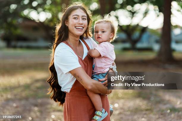 loving mom and one year old baby enjoying time outside - mãe solteira imagens e fotografias de stock