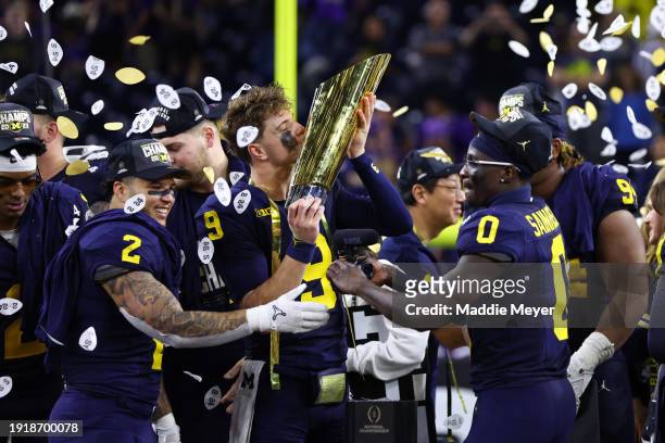 McCarthy of the Michigan Wolverines kisses the national championship trophy after defeating the Washington Huskies during the 2024 CFP National...