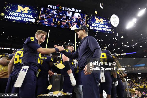 McCarthy of the Michigan Wolverines celebrates with Head coach Jim Harbaugh after defeating the Washington Huskies during the 2024 CFP National...