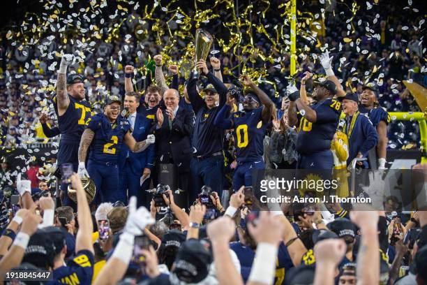 Trevor Keegan, Blake Corum, J.J. McCarthy, Head Football Coach Jim Harbaugh, Mike Sainristil, and Kenneth Grant of the Michigan Wolverines celebrate...