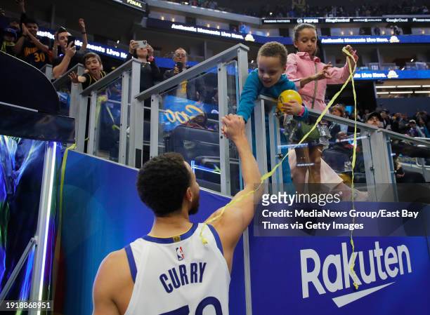 Golden State Warriors' Stephen Curry is congratulated by his son Canon as his daughter Riley looks on after their 121-115 NBA win against the Orlando...