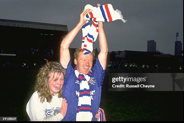 Maurice Mo Johnston of Rangers celebrates with a fan after the Scottish Premier Division match against Dundee United at Ibrox Park in Glasgow,...