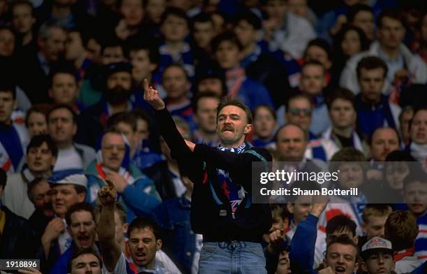 Rangers supporter makes a rude gesture during the Scottish Premier Division match against Celtic in Glasgow, Scotland. Celtic won the match 2-0. \...