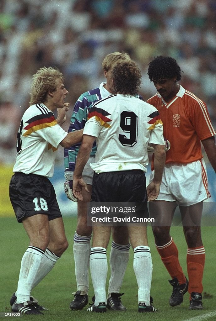 Jurgen Klinsmann and Rudi Voller both of West Germany and Frank Rijkaard of Holland in discussion