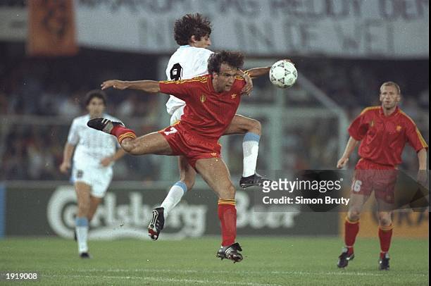 Stephane Demol of Belgium and Enzo Francescoli of Uruguay both go for the ball during the World Cup match in Verona, Italy. Belgium won the match...