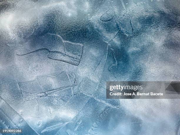 abstract background, translucent frosted glass of soft blue color with cracks. - bernat bacete stock pictures, royalty-free photos & images