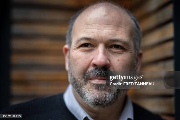 French journalist and deputy chief editor of "Le Telegramme" newspaper, Pascal Bodere, poses with a copy of his book "Bugaled Breizh, l'enquête" in...