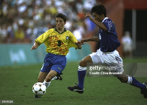Juninho of Brazil takes on Toshihiro Hattori of Japan during the Football event at the Centennial Olympic Games in Atlanta, Georgia. Japan beat...