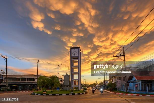 mammatus cloud at sunset over clock tower in small city - ominous clock stock pictures, royalty-free photos & images