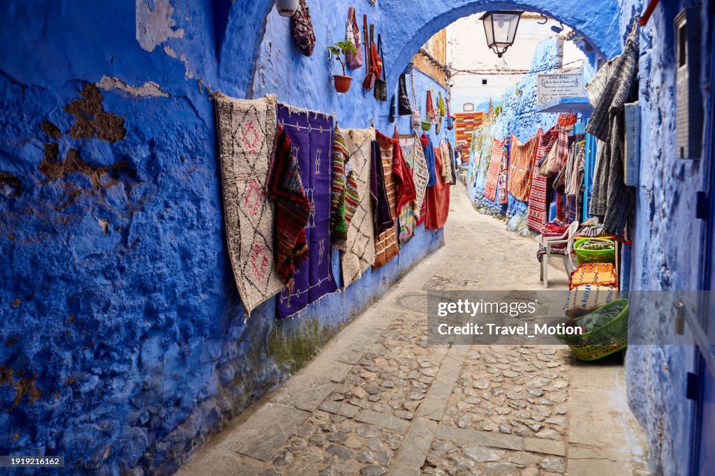 Street with handmade Maroccan rugs in Chefchaouen, Morocco