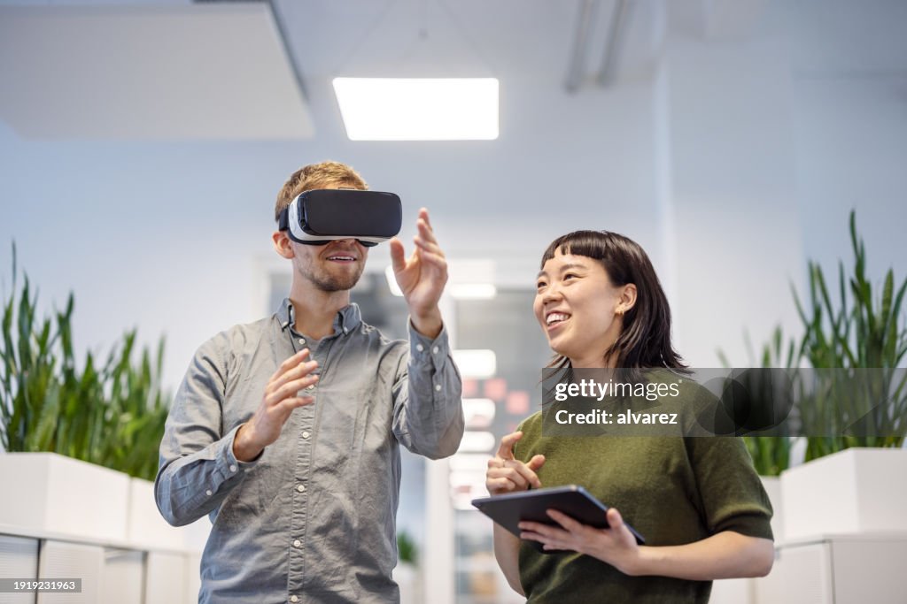 Business professionals testing the new virtual reality software in office