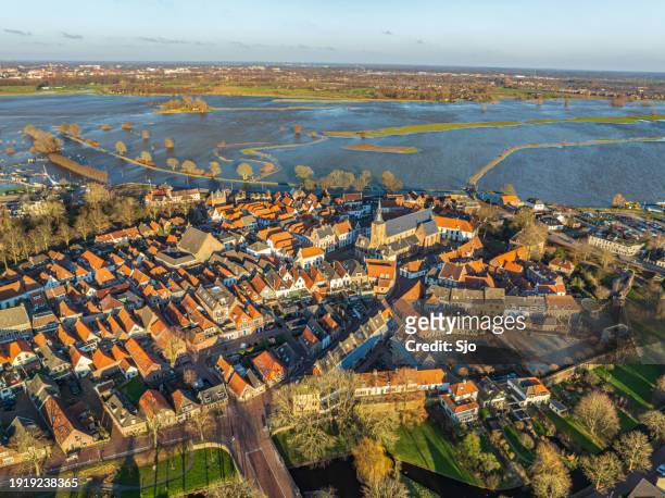hattem on the riverbank of the ijssel river with overflowing floodplains after heavy rainfall - overflowing river stock pictures, royalty-free photos & images