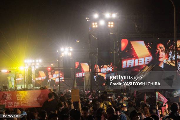 Electronic screens show the portrait of Lai Ching-te, presidential candidate for the ruling Democratic Progressive Party , during an election...