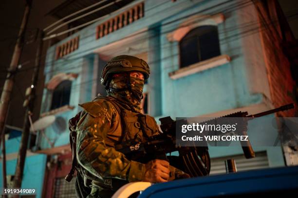 Soldier from the 5th Infantry Brigade keeps watch at the top of a pick-up truck during a security operation and search for suspects during the...