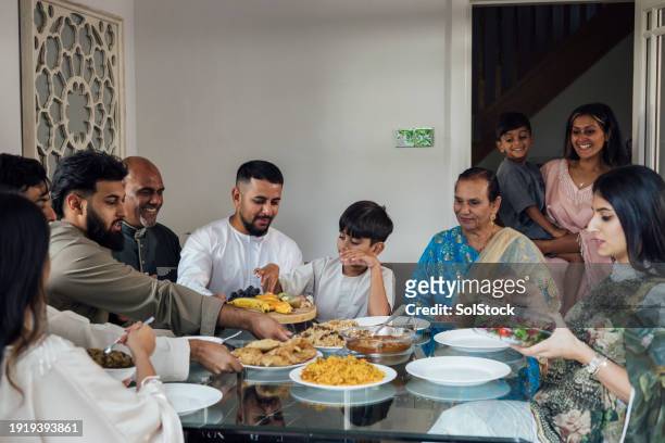 eid family dining delight - indian muslims celebrate eid ul fitr stock pictures, royalty-free photos & images