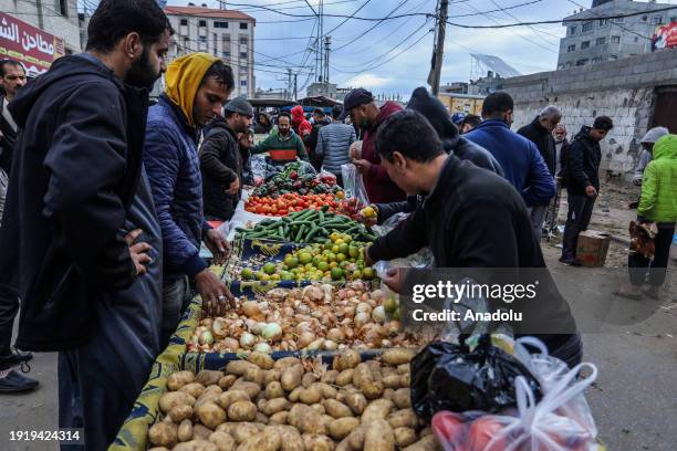 People shop at a street market to meet their daily needs under difficult circumstances amid Israeli attack in Rafah, Gaza on January 12, 2024.
