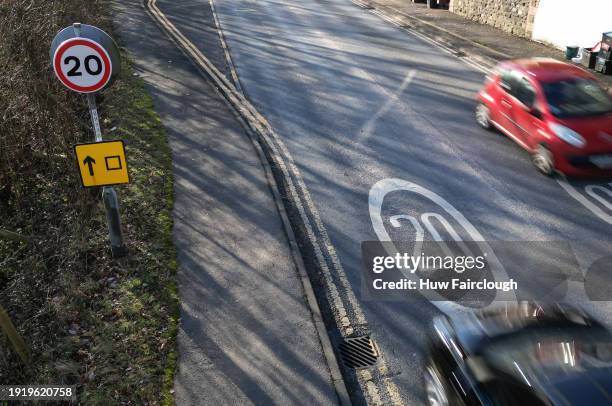 An aerial photograph of a 20mph Roadside sign and a 20mph road marking placed on the A467 near a school on January 09, 2024 Abertillery Wales. A...