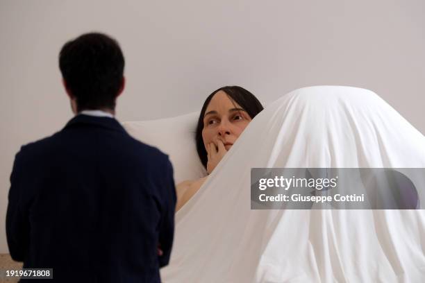 Visitors look at the work titled “In Bed”, 2005 by Australian-born artist Ron Mueck at Triennale di Milano on January 09, 2024 in Milan, Italy.