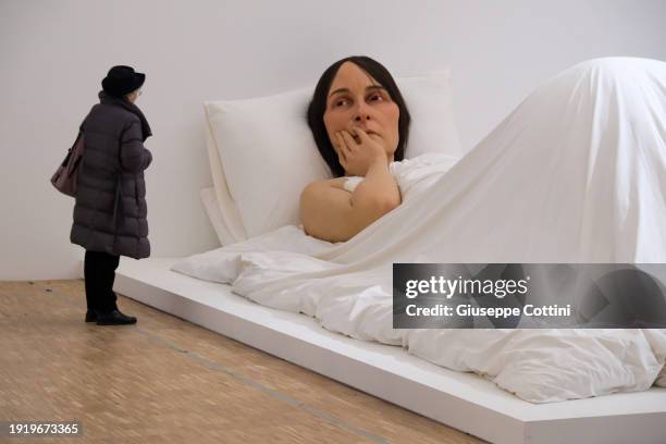Visitors look at the work titled “In Bed”, 2005 by Australian-born artist Ron Mueck at Triennale di Milano on January 09, 2024 in Milan, Italy.