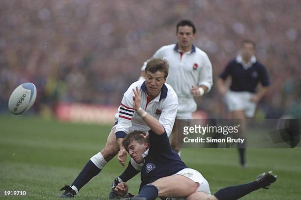 Rob Andrew of England is tackled by Craig Chalmers of Scotland during the World Cup semi-final at Murrayfield in Edinburgh, Scotland. England won the...