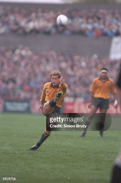 Michael Lynagh of Australia kicks the ball forward during the World Cup semi-final against New Zealand at Lansdowne Road in Dublin, Ireland....
