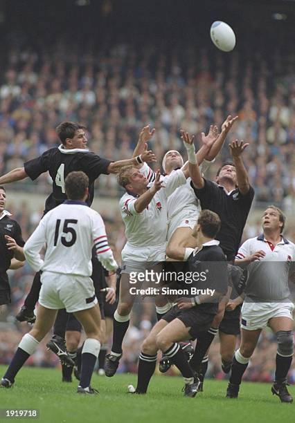 Paul Ackford and Peter Winterbottom of England jump for possession of the ball with Ian Jones of New Zealand during the World Cup match at Twickenham...