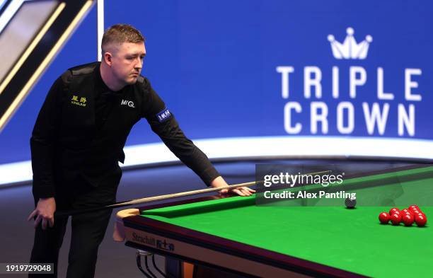 Kyren Wilson of England looks down the table during his first round match against Judd Trump of England during day three of the MrQ Masters Snooker...