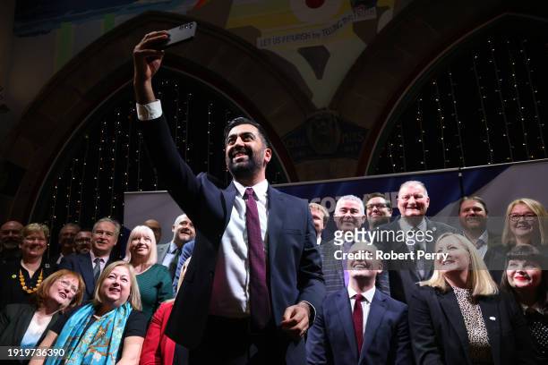 Humza Yousaf, Scottish First Minister and leader of the SNP takes a "selfie" with delegates during the launch of the SNP general election campaign at...