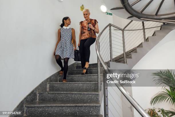 leaving office together - spiral staircase stockfoto's en -beelden