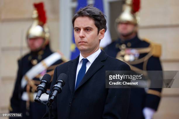 France's newly appointed Prime Minister, Gabriel Attal listens to the speech of outgoing Prime minister Elisabeth Borne during the handover ceremony...
