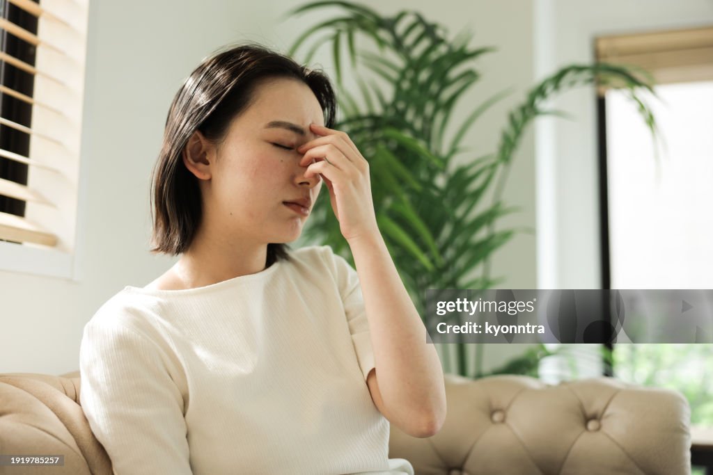 Asian woman with headache