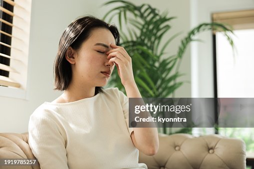 Asian woman with headache Asian woman with headache