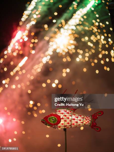 fireworks and fish lantern in a traditional lantern festival celebration in china - chinese lantern stock-fotos und bilder