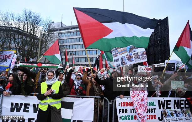 Palestine supporters gather in front of the International Court of Justice building to demonstrate with Palestinian flags and banners during the...