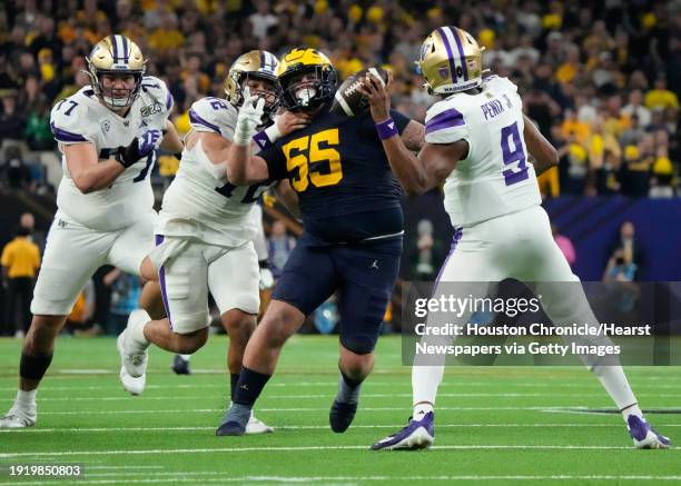 Michigan Wolverines defensive lineman Mason Graham pressures Washington Huskies quarterback Michael Penix Jr. During the national championship NCAA...