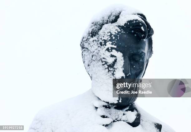 Snow covers half the face of former U.S. President Abraham Lincoln's statue at the Iowa State Capitol building on January 09, 2024 in Des Moines,...