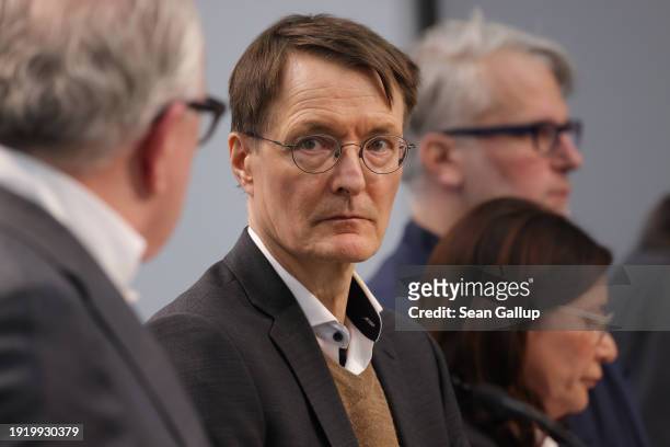 German Health Minister Karl Lauterbach stands with physicians representatives as he speaks to the media following a summit with physicians...