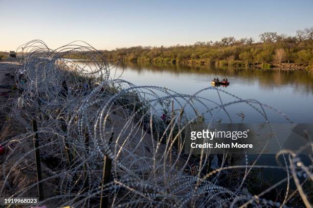 National Guard soldiers stop to talk while patrolling the Rio Grande at the U.S.-Mexico border on January 09, 2024 in Eagle Pass, Texas. Immigrant...