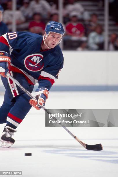New York Islander's forward, Claude Loiselle, in the process of making a pass during the game against the NJ Devils at the Meadowlands Arena on...