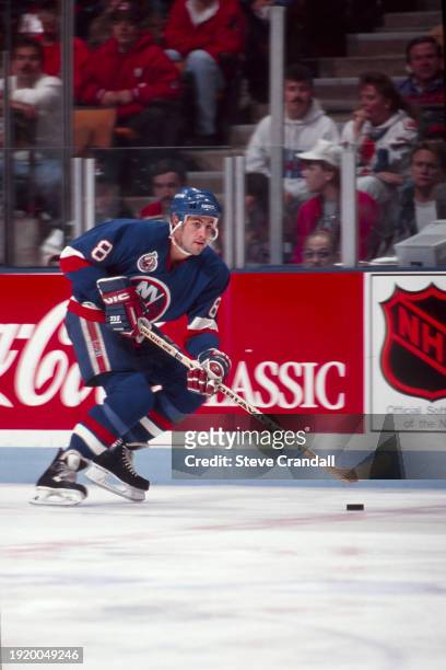 New York Islander's defenseman, Jeff Norton, has control of the puck as he skates out of his zone, looking to make a pass during the game against the...