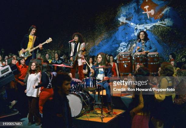 English rock band T. Rex perform on the set of a pop music television show in London circa 1970. Members of the group are, from left, bassist Steve...
