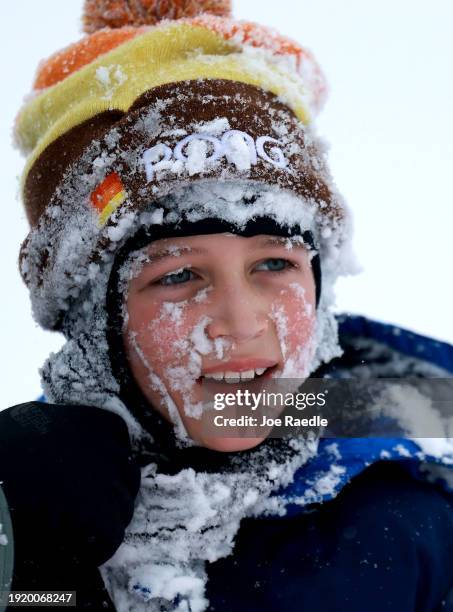 Harrison Casper is covered in snow as he enjoys sledding near the Iowa State Capitol building on January 09, 2024 in Des Moines, Iowa. A weather...