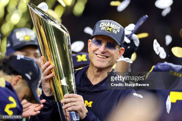 Head coach Jim Harbaugh of the Michigan Wolverines celebrates after defeating the Washington Huskies during the 2024 CFP National Championship game...